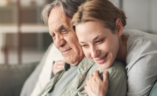 Woman hugging senior man with Alzheimer's, debunking the myths about dementia
