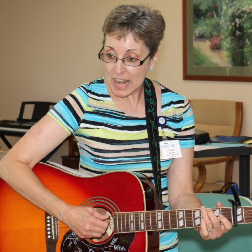 Therapist provides music therapy in a senior community
