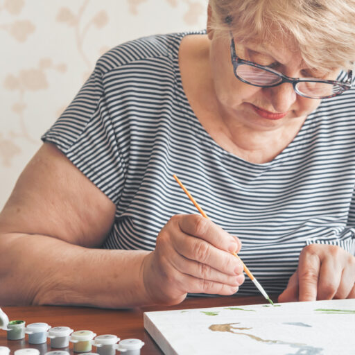 Woman making art as part of senior dementia care