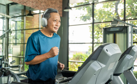 Senior man on treadmill, an exercise that may be more enjoyable for introverted people