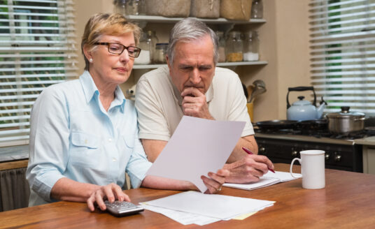 Senior couple looking over their end of life planning for National Healthcare Decision day.