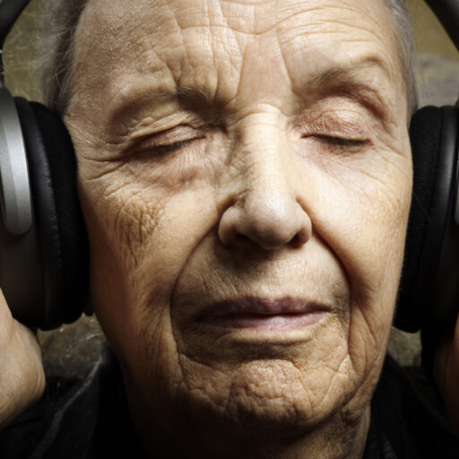 Bethesda music therapy for seniors can range from listening to music, like the senior in this photo, or playing music! The benefits of music therapy for seniors include improved memory and reduced stress.