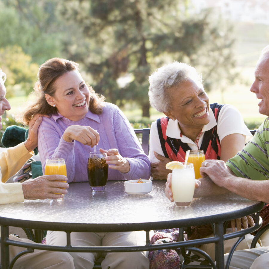 Group of senior friends at a retirement community. Studies have shown that seniors live longer at retirement communities - and they are happier too!