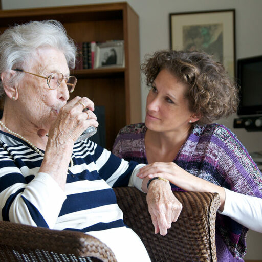 Caring for someone with dementia is a challenge, but it is also rewarding. Here, a daughter cares for her aging mother.