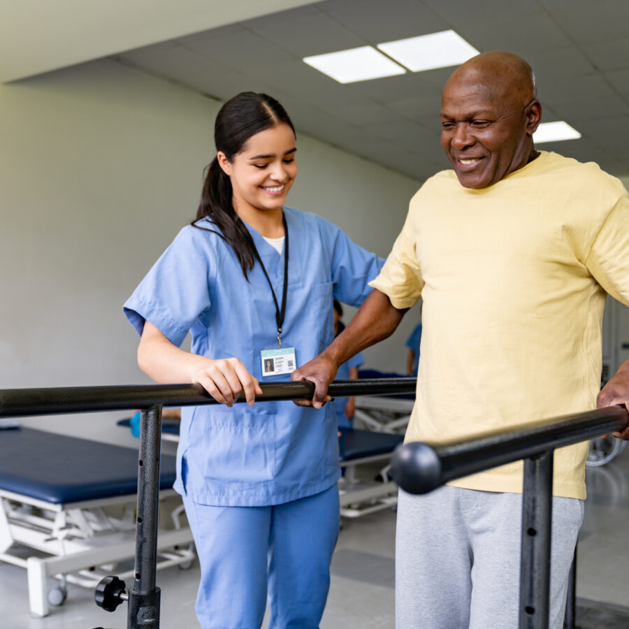 Senior experiencing rehabilitation benefits while being assisted by rehab specialist