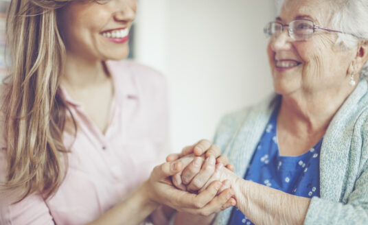 A friendly interaction between a senior woman and a woman who works in senior care. A career in senior care is rewarding because you are able to help others and form meaningful relationships, like the one found in this picture.