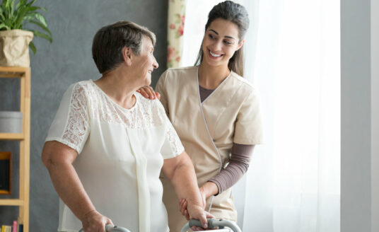 Planning ahead for assisted living or other long-term care options allows seniors, like this woman, to find the care that they need without feeling rushed. Here, a nurse chats with a senior woman at an Assisted Living community.