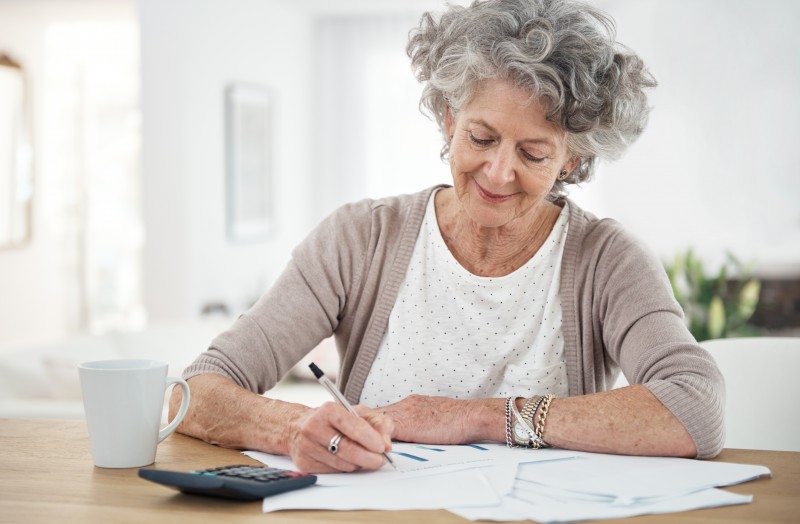 A senior woman reviewing her caregiving schedule, as time management is crucial for a family caregiver.