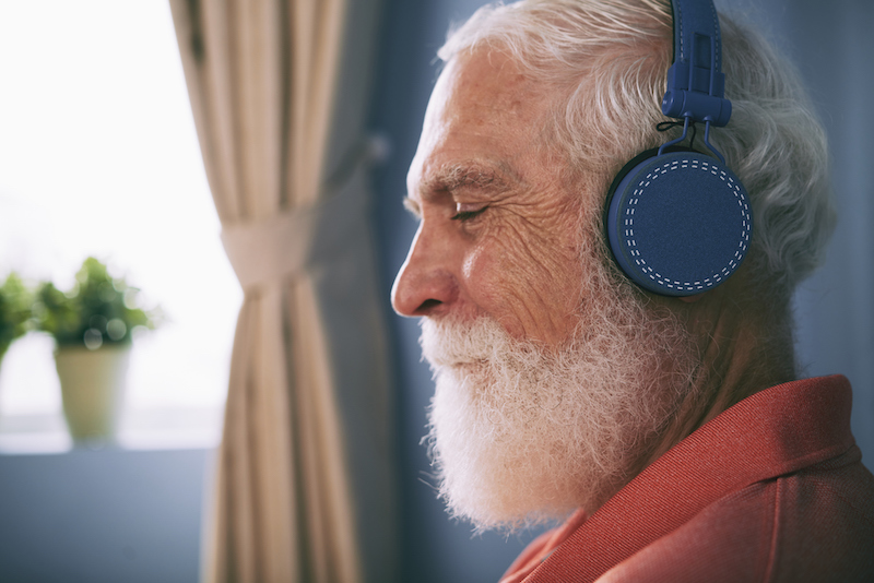A man listens to music to manage sundown syndrome