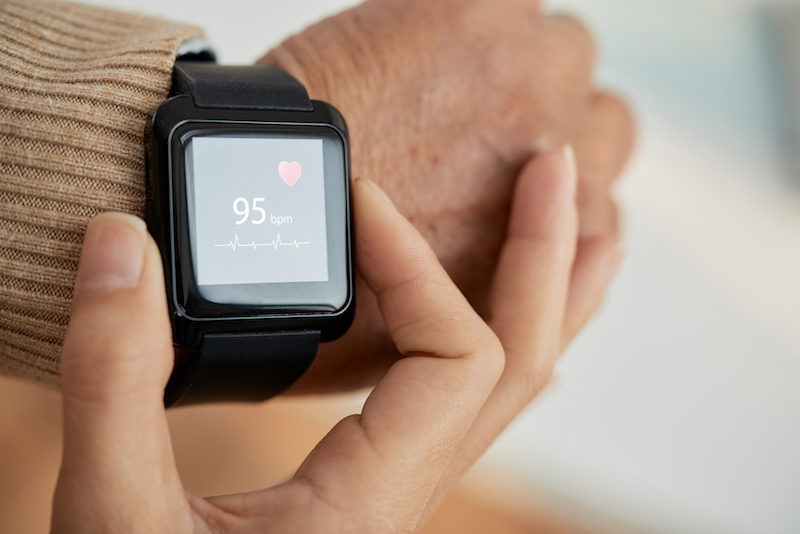 A senior wears an Apple watch to prevent heart disease