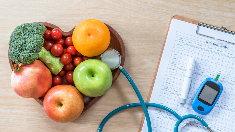 A plate of fruits, vegetables, and medical tests to help seniors manage diabetes