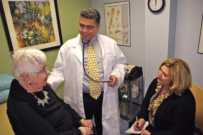 A senior woman gets checked out by a doctor with the benefits of a care manager