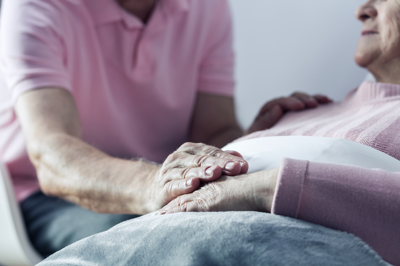 A man communicating with a hospice patient