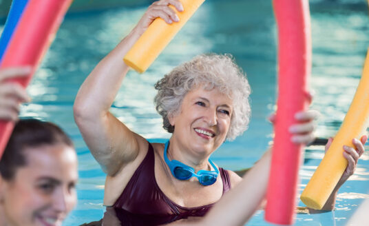 A woman participating in water aerobics for seniors