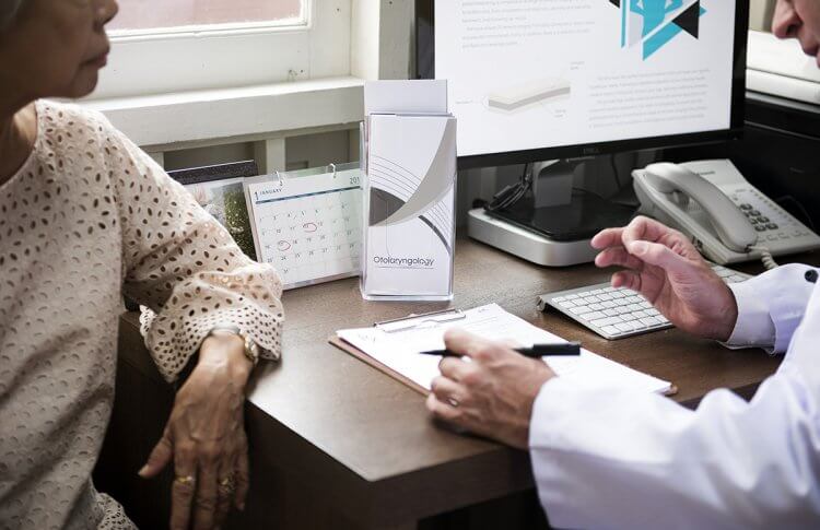 By learning how to effectively communicate with your doctor, you can improve your overall health. Here, an older woman talks with her doctor.