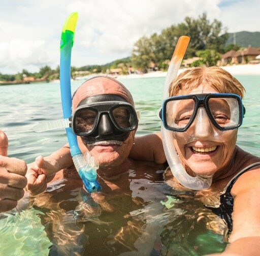 Two older adults enjoy their summer vacation as family caregivers using a respite care service.