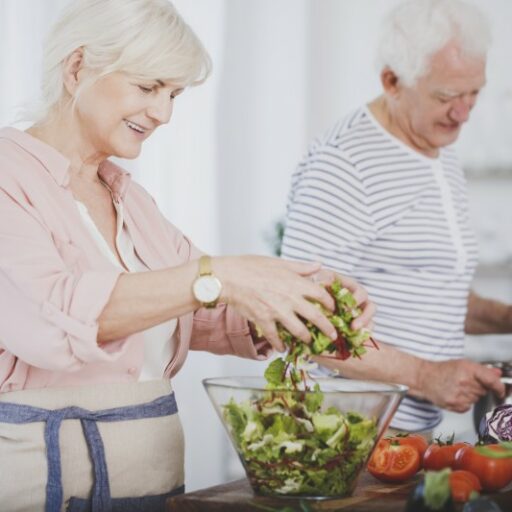 An older adult couple prepares a healthy meal at home, to better manage diabetes