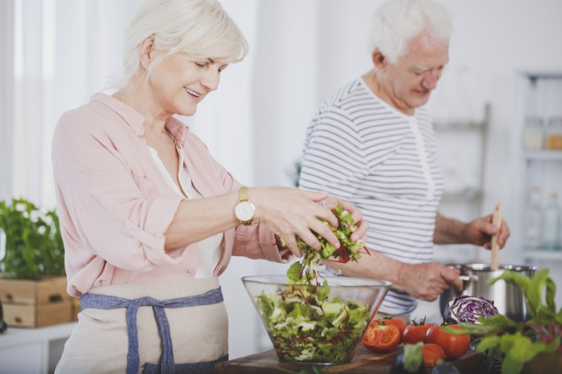 An older adult couple prepares a healthy meal at home, to better manage diabetes