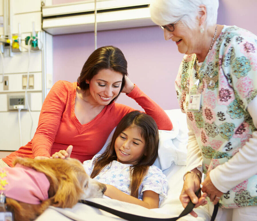 If you're looking for a meaningful retirement, try volunteering at a children's hospital. Here, a senior woman volunteers and visits with a child and her mother.