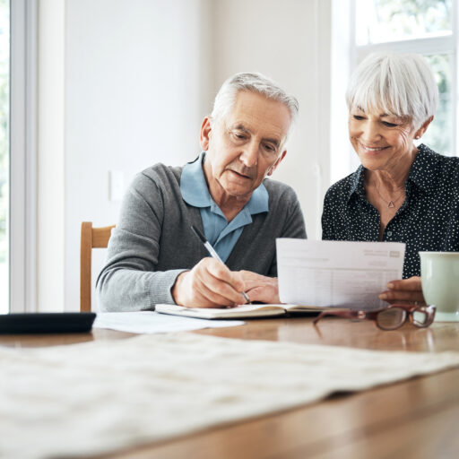 A senior couple reviews their budget and how they save and spend during retirement.