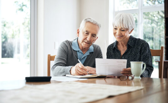 A senior couple reviews their budget and how they save and spend during retirement.