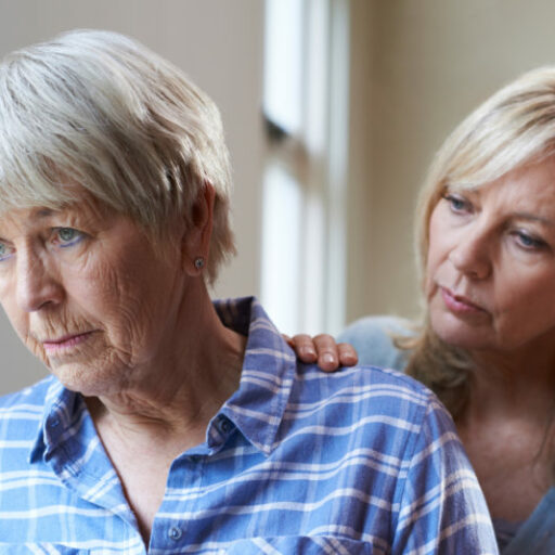 An adult woman talks with her mother as they consider memory care.