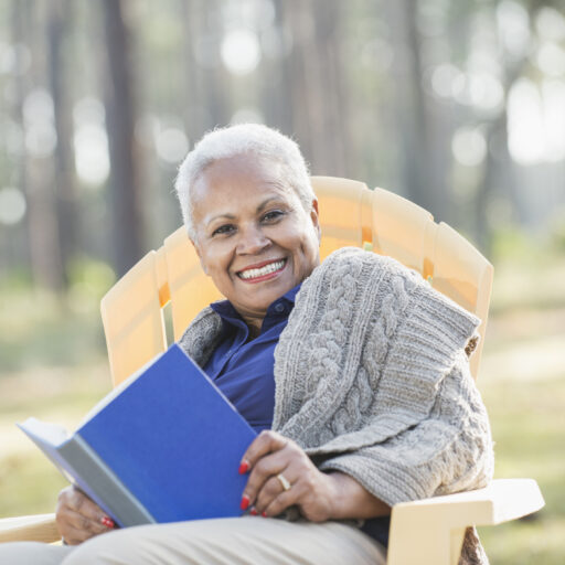 Women relaxes and celebrates her move to an assisted living community in autumn.