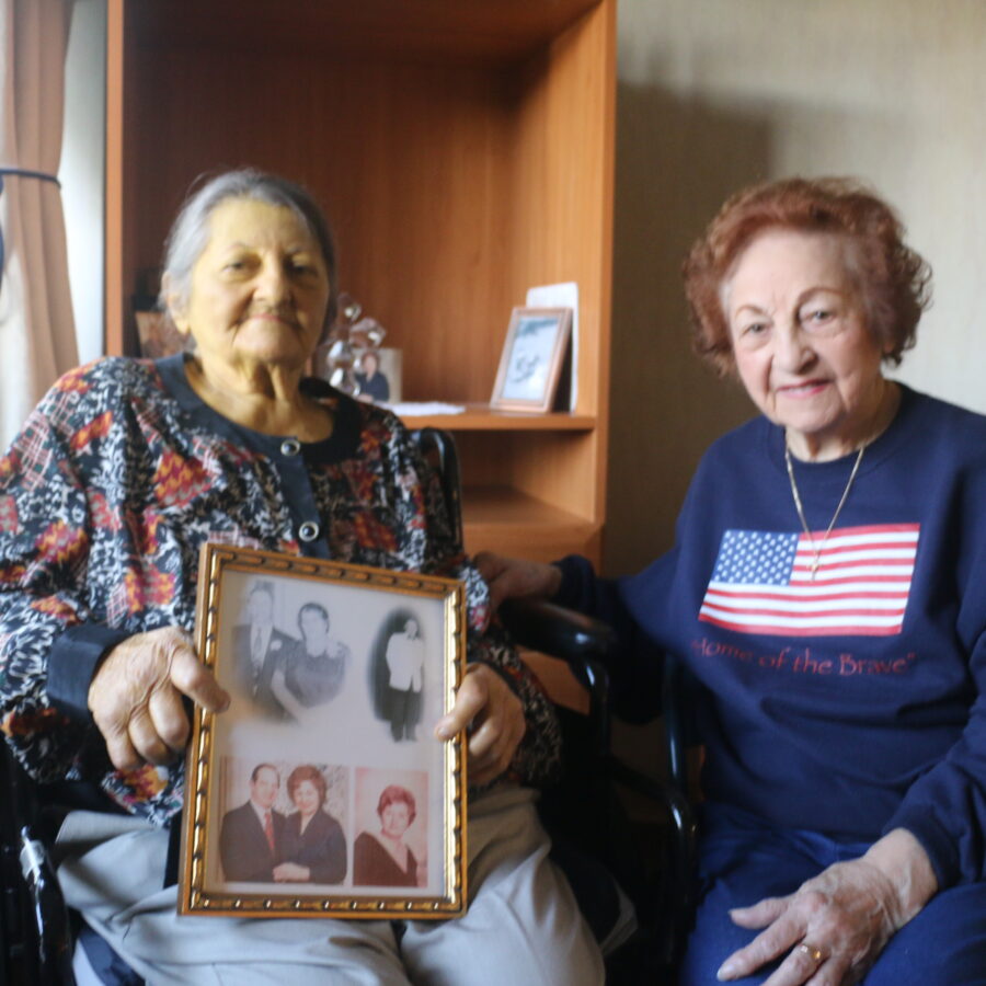 Dena Marmigas, a hospice care resident at Bethesda Dilworth, sits with her sister Mary, as they celebrate their heritage.