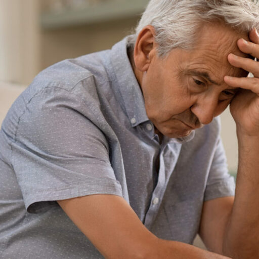 Elderly man looks stressed as he struggles with how to fight loneliness as a senior.