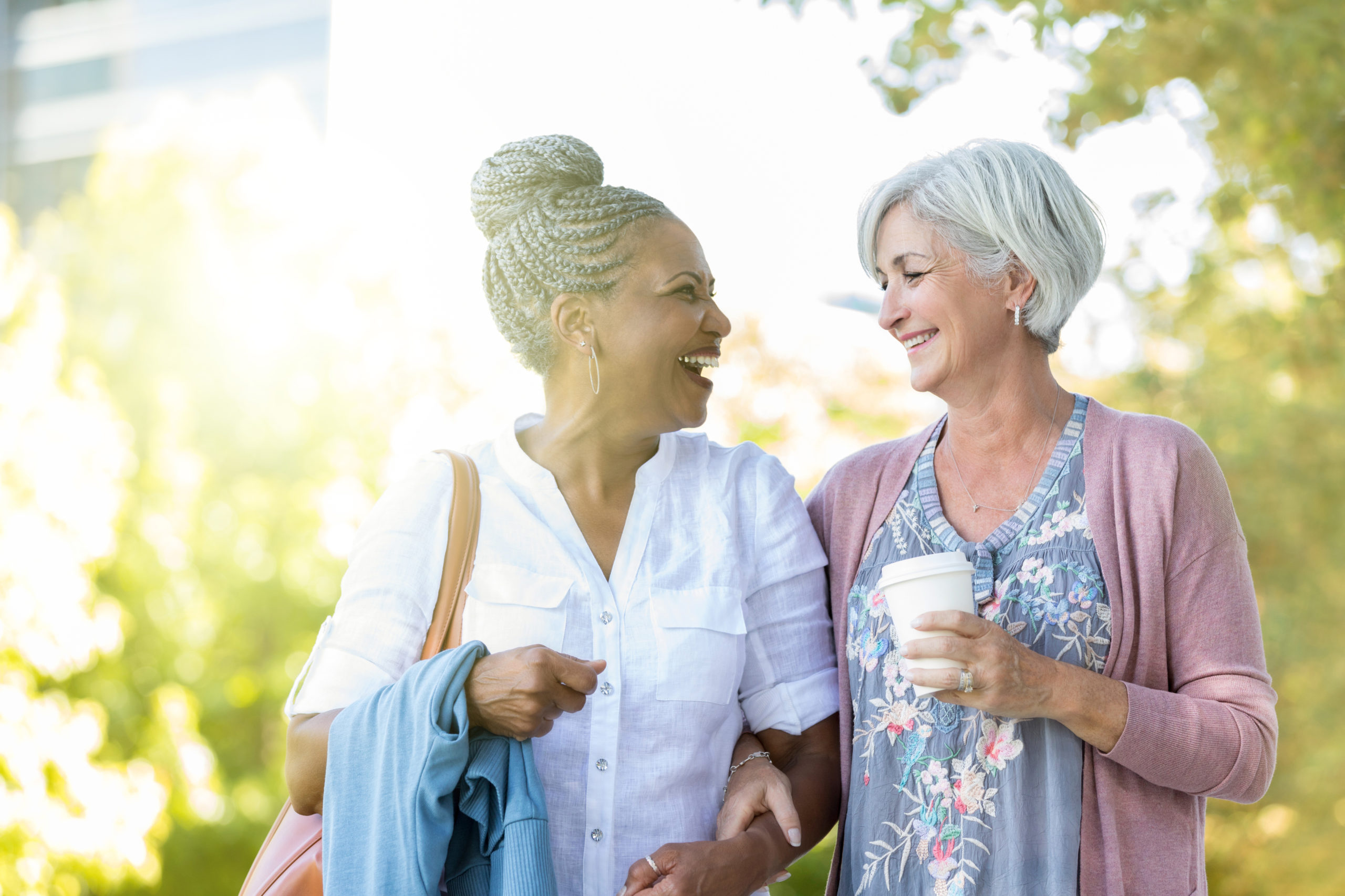 Two women walking in park | Honor caregivers in your life