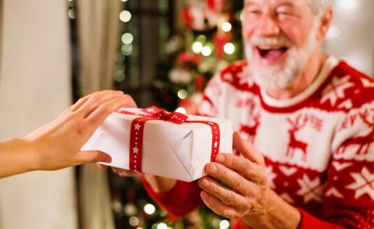 A senior man receives a holiday gift