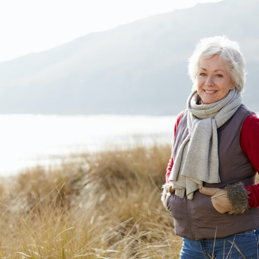 A senior woman focuses on winter health by getting outside on a nice winter day.