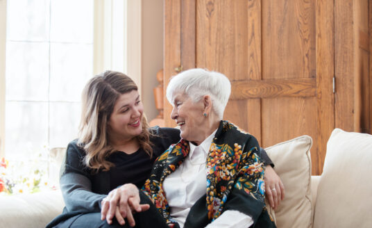 A woman talks to her senior mother about the benefits of assisted living