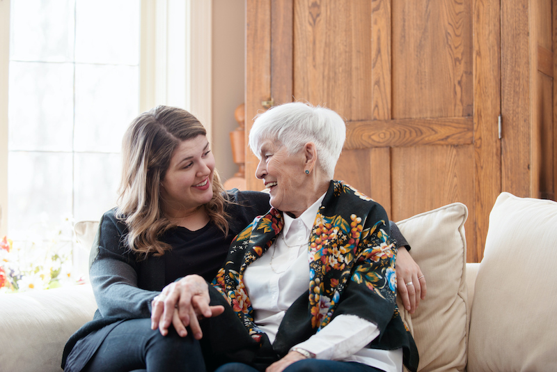 A woman talks to her senior mother about the benefits of assisted living