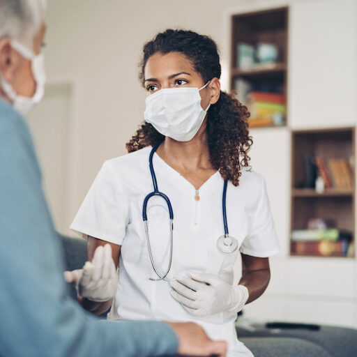 Young female doctor talking to a senior patient at annual checkup
