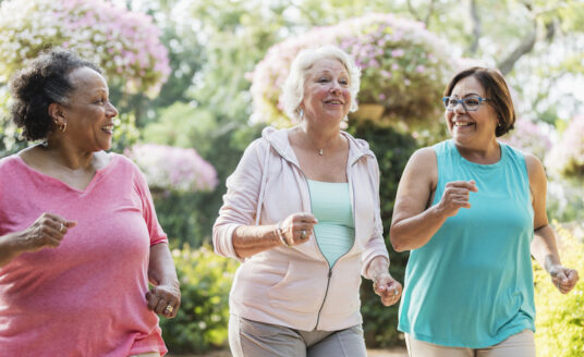 Multi-ethnic senior women walking together for the benefit of their health.