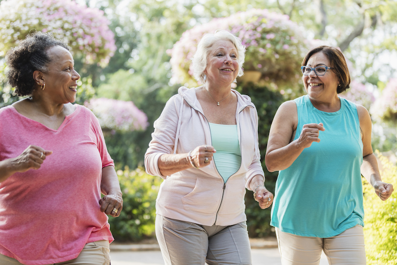 Multi-ethnic senior women walking together for the benefit of their health.