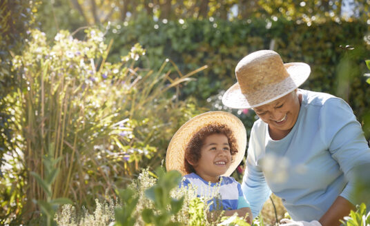 Senior and child gardening outdoors in the spring. | Spring Activities for Seniors