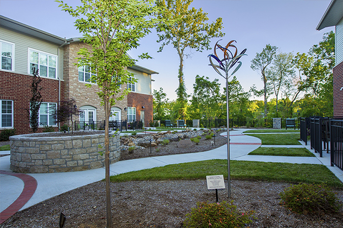 An image of Bethesda Hawthorne's courtyard with gardens and newly planted trees