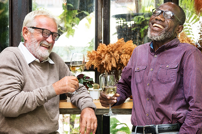 Two men sharing a drink and laughing