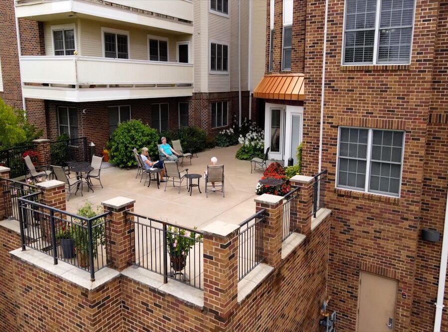 two seniors enjoy an enclosed patio at Bethesda Gardens