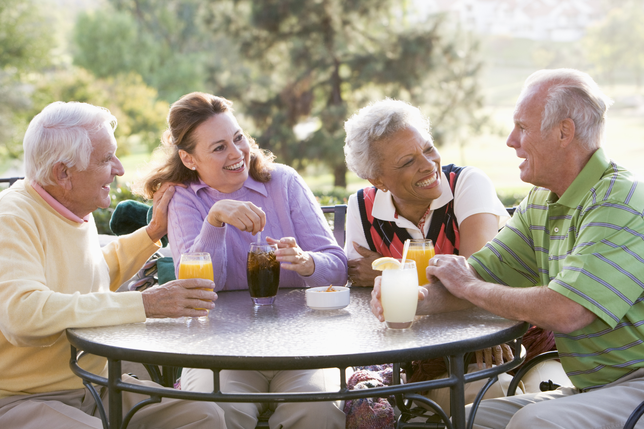 Group of senior friends at a retirement community. Studies have shown that seniors live longer at retirement communities - and they are happier too!