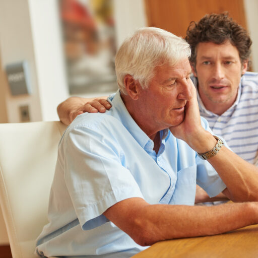 Son Talking to Senior Father About Stages of Dementia