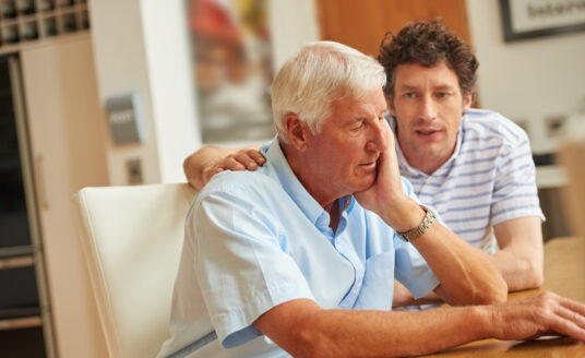 Son Talking to Senior Father About Stages of Dementia