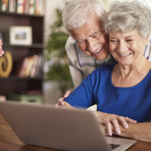 Senior couple looking at the computer, searching for an independent retirement community in St. Louis.