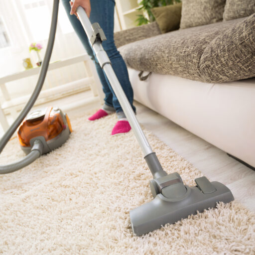 Vacuum running across carpet in seniors home for spring cleaning.