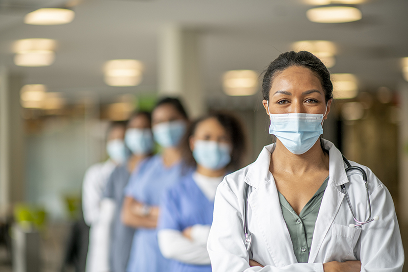 A line of doctors and nurses wearing face masks