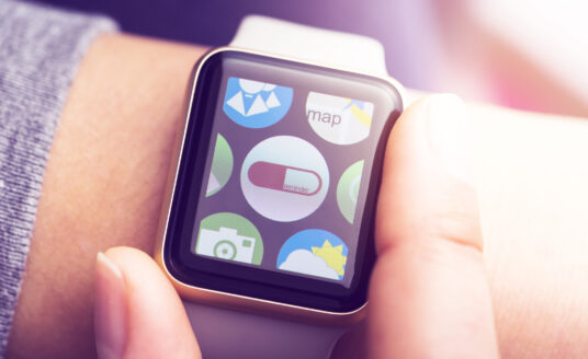 Woman wearing smart watch with pill reminder application for managing medications