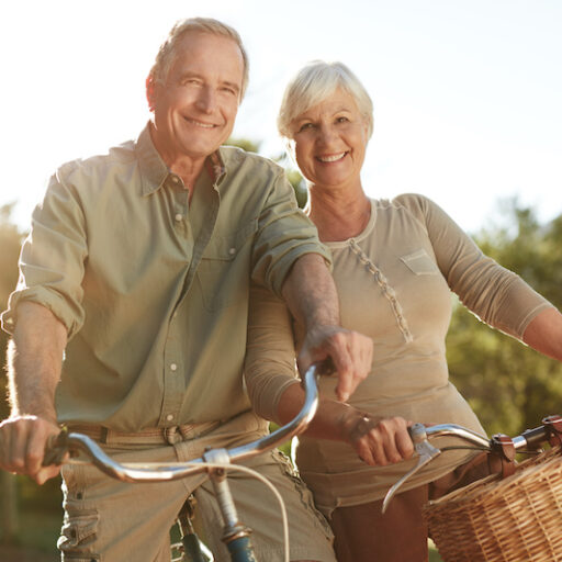 A senior man and woman avoid cognitive decline by getting exercise on a bike ride.