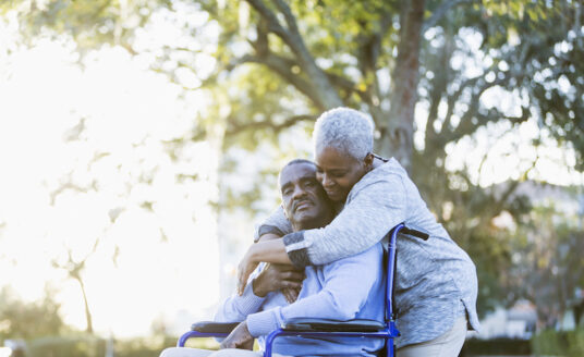 Senior Man in Wheelchair with his Senior Caregiver